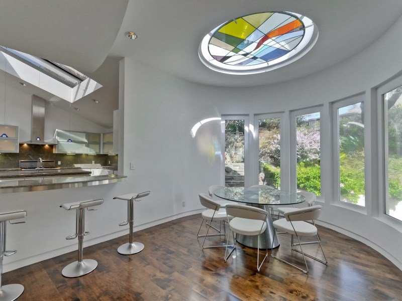 a-small-dining-area-has-a-stained-glass-window-as-a-skylight
