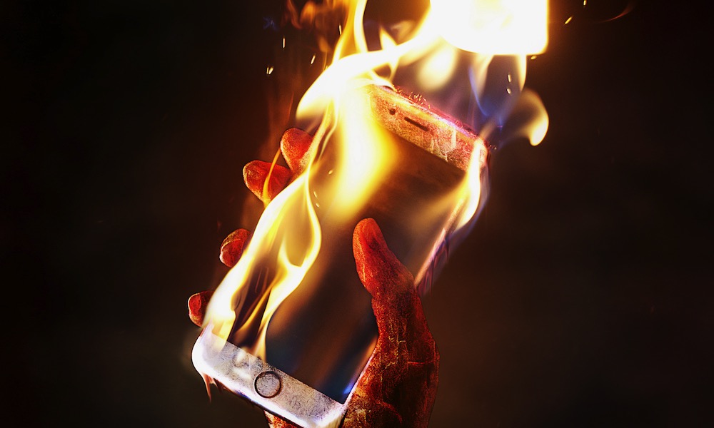 iPhone on Fire Burning in Hand Excessive Heat Damage