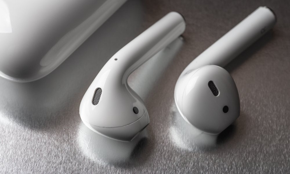 AirPods on Table Beside Case