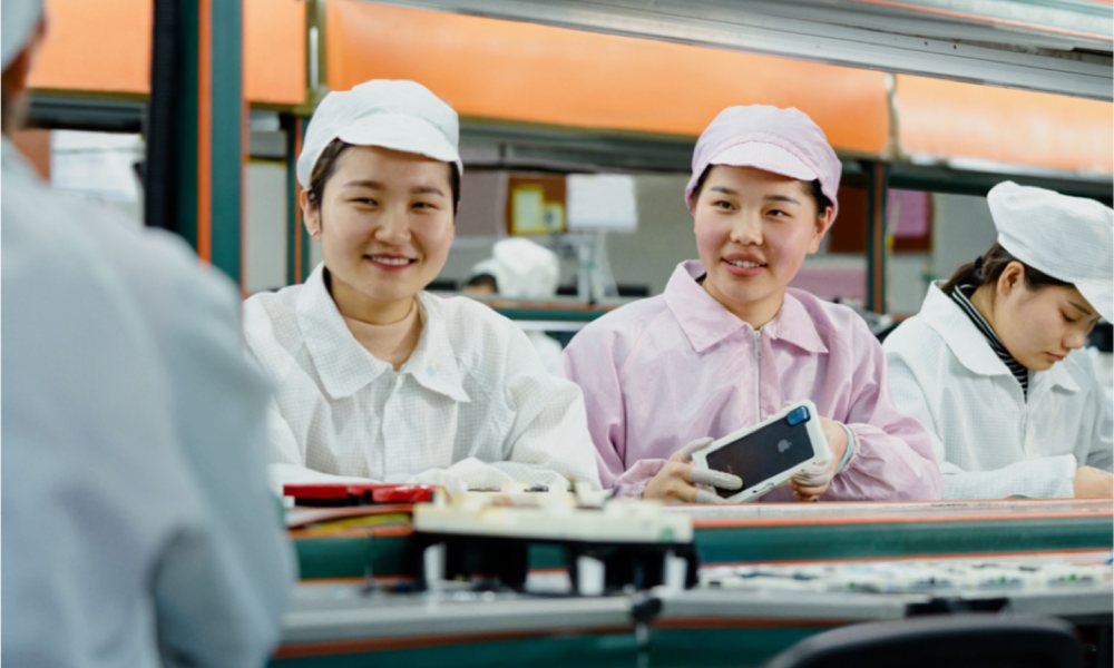 Apple Chinese Factory Workers Holding iPhone