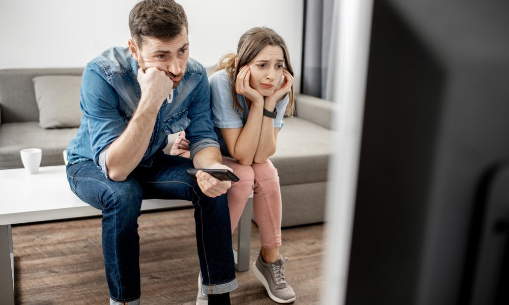 Man And Woman Bored And Frustrated In Front Of Tv
