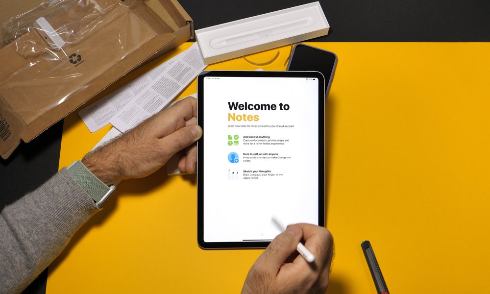 Man Holding iPad With Apple Pencil Notes Intro Screen