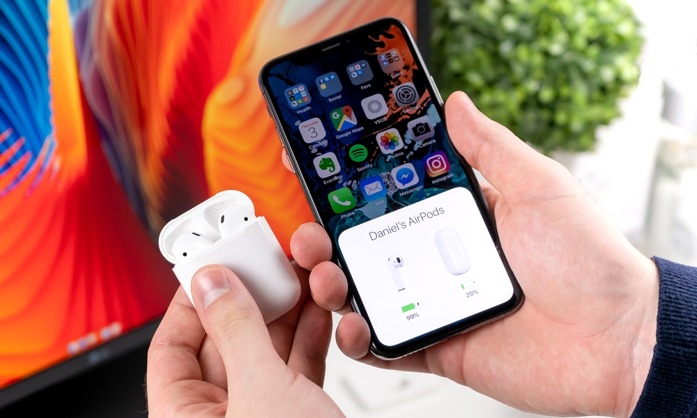 AirPods Pairing with iPhone in front of colourful screen