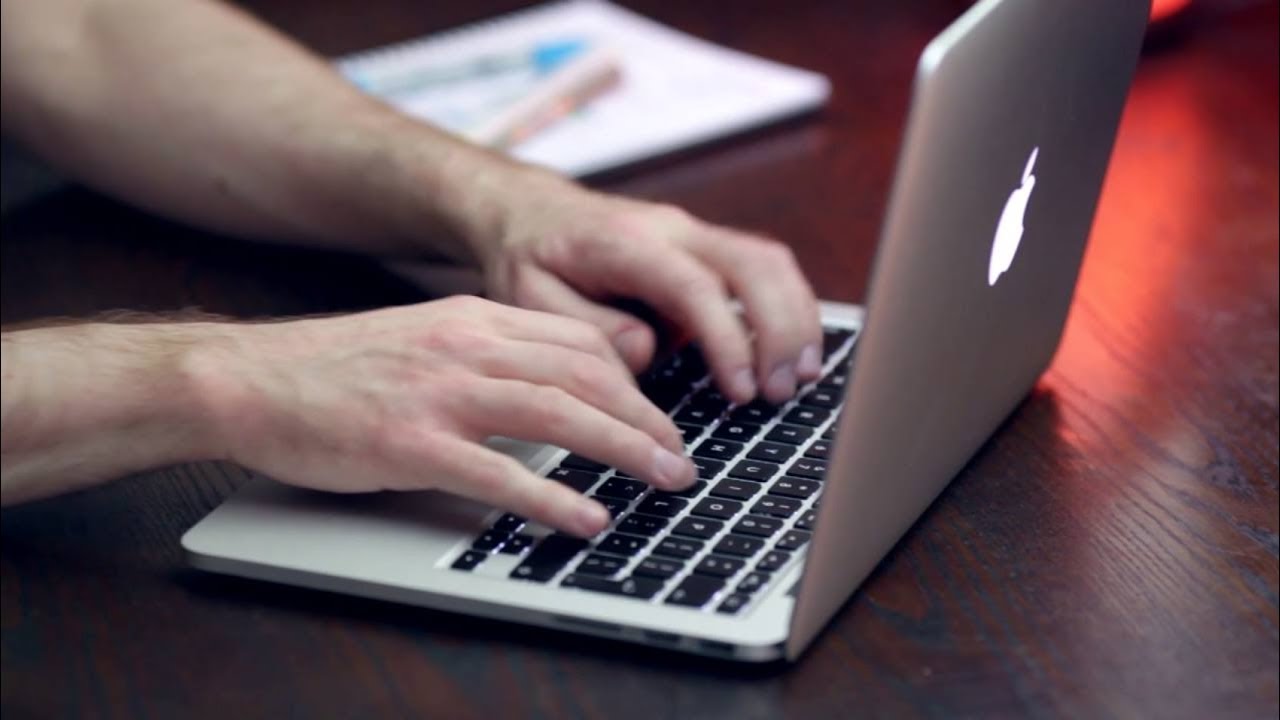 Man's Hands Typing On Macbook Keyboard