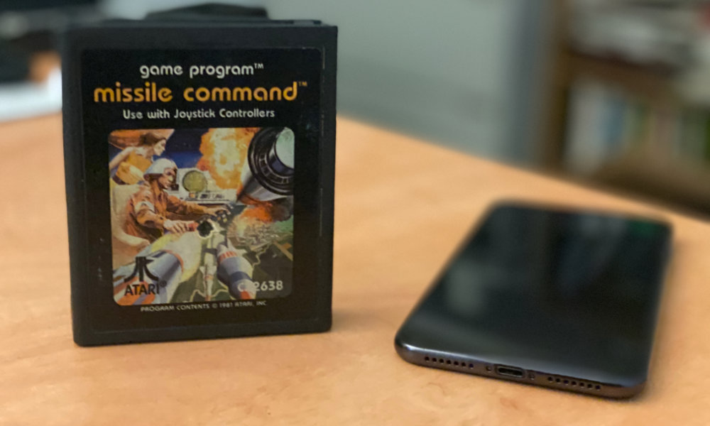 Missile Command cartridge with iPhone upright