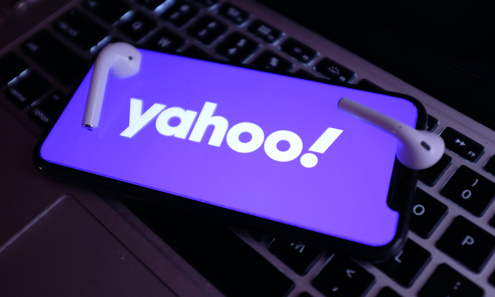 Yahoo logo on iPhone 11 with AirPods