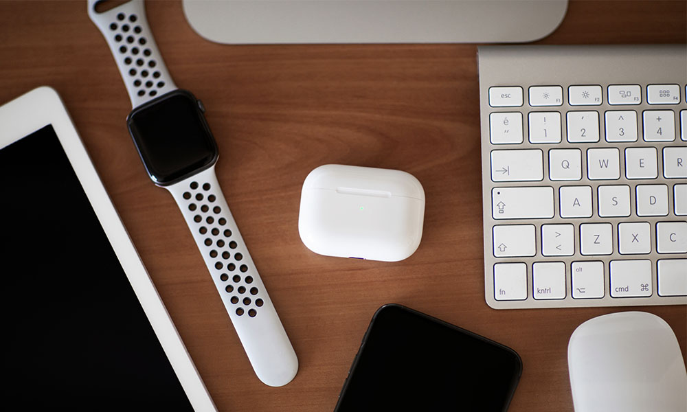 Apple products on desk AirPods Keyboard Apple Watch