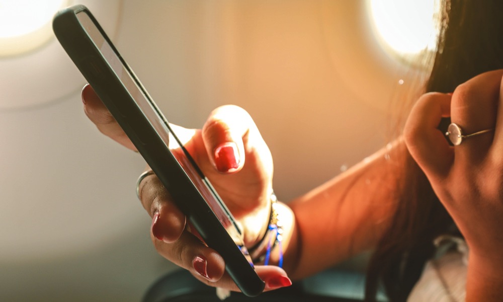 Woman on Airplane Using a Smartphone