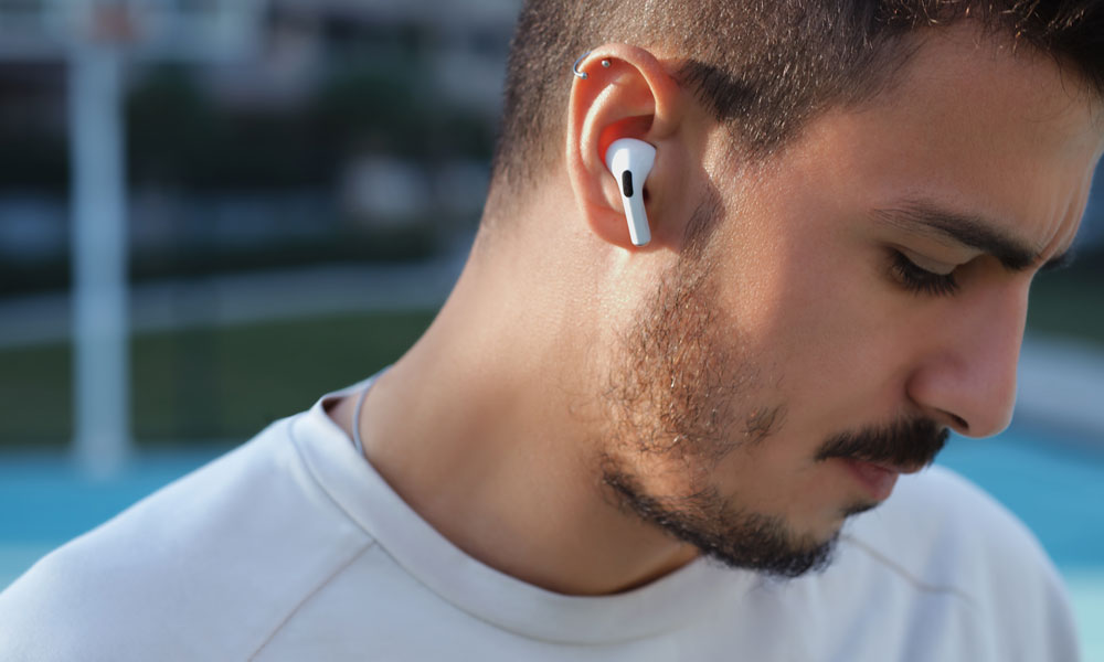 Man with beard wearing AirPods looking down