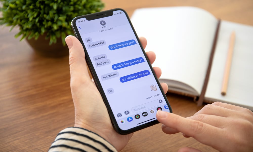 Woman using iMessages on iPhone X