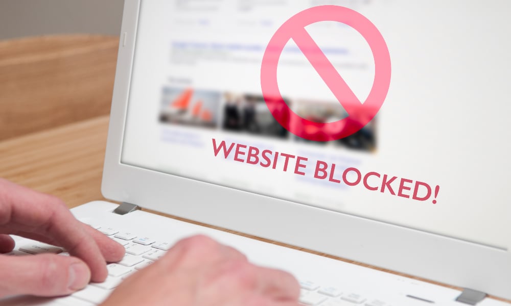 person visiting blocked website on laptop