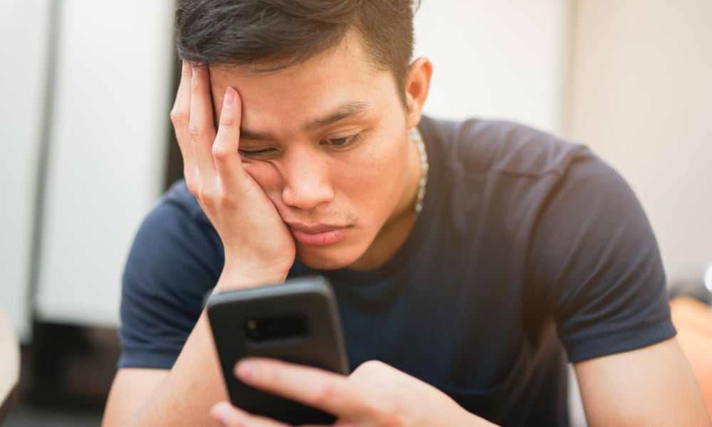 man frustrated by slow smartphone