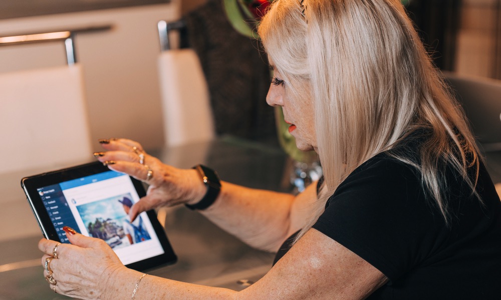 Older woman using an iPad or similar tablet