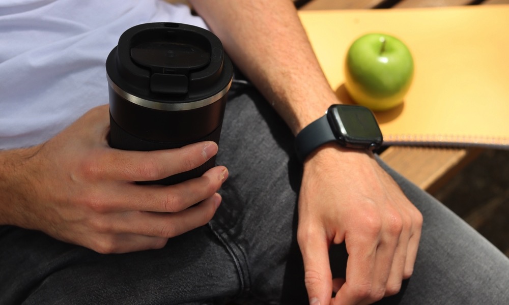 Man wearing Apple Watch with food and coffee